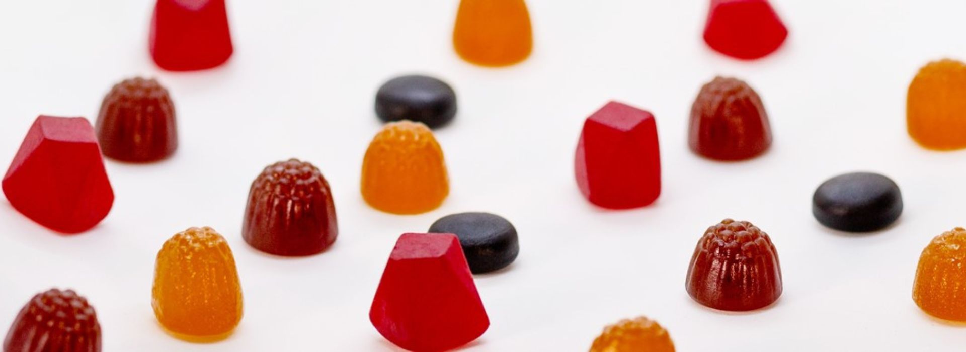 Different coloured gummies on white